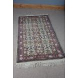 Persian style rug, the cream ground decorated with floral designs and multiple borders and tassel