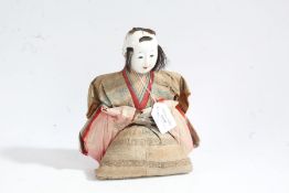 Japanese straw filled doll, 20th century, with carved wooden hands, 23cm tall