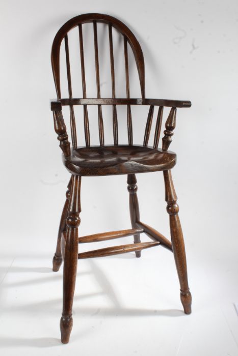 20th century oak windsor childs chair, the arched back with turned splats and supports raised on