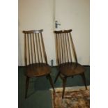 Pair of mid 20th century Ercol chairs, baring label and stamp to underside of seat, with a wavy