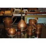 Seven items of copper including four graduated tankards and a funnel