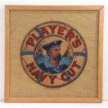 Player's Navy Cut cardboard logo, now trimmed and presented in a glazed frame, 46.5cm wide, 46cm