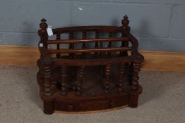 A 19th century walnut Canterbury, with turned supports and a serpentine body and a single door to