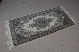 A Keshan rug, the cream ground with a central floral medallion together with multiple floral