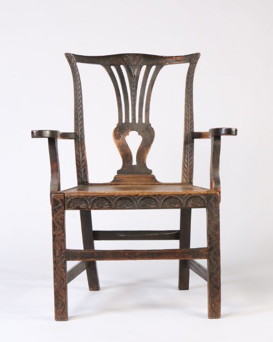 A 19th Century Suffolk 'Farmer's Chippendale' oak country armchair, serpentine top-rail, pierced