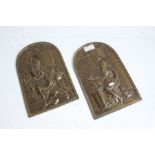 Pair of brass wall plaques depicting religious figures, 25cm high