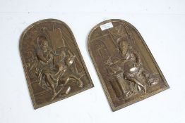 Pair of brass wall plaques depicting religious figures, 25cm high