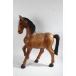 20th century floor standing wooden horse, with black mane and tail, 78cm tall, 54cm long