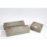 Three Art Nouveau glove boxes, the grey ground decorated with poppys, the largest 34cm wide