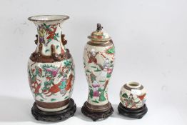 Two 20th century Chinese crackle glazed vases, each painted with warriors in battle, the tallest