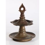 19th Century Indian temple bronze oil lamp, the finial above reservoir raised on a dished base, 25.