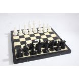 20th century chess board, with a black and white plastic chequered board together with chess pieces