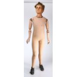 A 19th century life-size mannequin of a boy, with modelled wax head, real hair, glass eyes, the