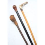 Three various walking sticks, one with an antler handle, another with a leather top (3)