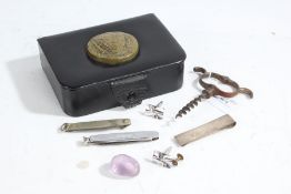 Black leather box containing a silver clip, pair of cufflinks, two penknives, corkscrew etc.