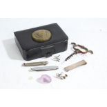Black leather box containing a silver clip, pair of cufflinks, two penknives, corkscrew etc.