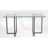 20th Century glass top dining table raised on black metal T shaped end supports, 140cm wide, 80cm