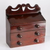 Mahogany spice cupboard, the heart and scroll pierced pediment above a sloped lidded compartment,