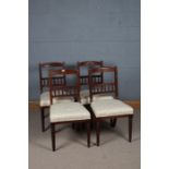 Set of four James Shoolbred mahogany and upholstered dining chairs, with a carved cresting rial