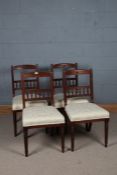 Set of four James Shoolbred mahogany and upholstered dining chairs, with a carved cresting rial