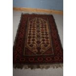 19th century Afghanistan style rug, the brick red and cream ground set with central floral design