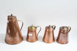 Four Victorian and later copper jugs/ewers, all with tapering bodys, largest 27cm high