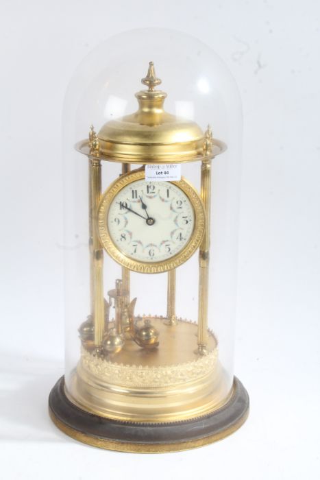 Large brass anniversary clock, the dial with arabic numerals and floral garlands, raised on six