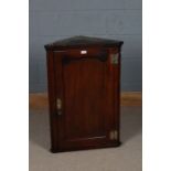 19th century mahogany hanging corner cupboard, with a single panel door opening to reveal two