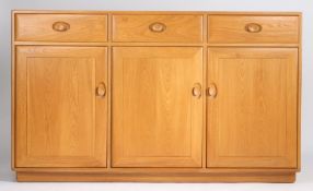 Blonde Ercol sideboard, fitted three drawers above three cupboard doors, 155cm long, 94cm high, 43.