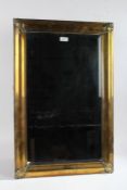 Rectangular brass framed wall mirror, with bevelled glass plate, 71cm long, 46cm wide