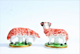 Pair of Samson porcelain sheep, a ram and ewe, psuedo Chelsea gold anchor mark to each, 8cm and