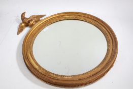 Regency style gilt circular wall mirror, surmounted with an eagle, 54cm diameter