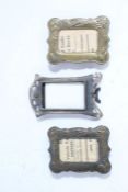 Three Art Nouveau miniature picture frames, two decorated with floral scenes and the other with a
