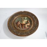 Large 20th wall plaque, with a circular rim decorated with scroll decoration and a scene of a man
