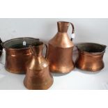 Two Eastern copper jugs, the largest 45cm tall, together with two swing handled pots (4)