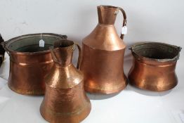 Two Eastern copper jugs, the largest 45cm tall, together with two swing handled pots (4)