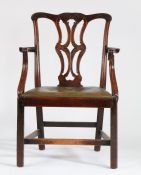 George III and later mahogany elbow chair, the swept acanthus leaf carved cresting rail above a