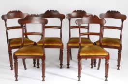 Set of six Regency mahogany dining chairs, the scroll carved cresting rails above curved splat