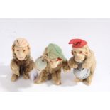 Three mid 20th century plush covered monkey band figures, probably Max Carl, each with cloth hats.