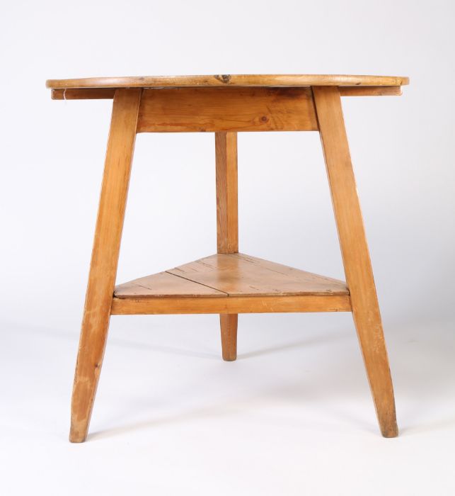 A 19th Century pine cricket table, circular plank top raised on three square tapered legs, with