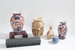 Two Japanese imari vases, together with two Japanese Satsuma vases, each decorated with figures, a