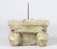 A limestone capital, converted to a sundial, probably 14th century Designed with corner animal