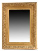 Substantial wall mirror, the acanthus leaf, beaded and foliate gold painted frame housing the
