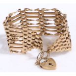 Large 9 carat gold gate link bracelet with a heart shaped locket, 15.5 grams