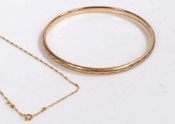 9 carat gold bangle with a metal core together with a 9 carat gold chain link necklace, gross weight