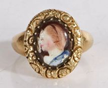 An enamel ring, the oval enamel head depicting a lady in profile with a yellow metal band, 4.4