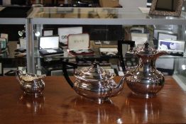 Three piece silver plated tea set, consisting of a tea pot, coffee pot and a milk jug, with ebonised