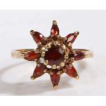 9 carat gold and garnet cluster ring, the head in the form of flower, ring size L weight 2.9 grams