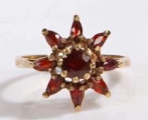9 carat gold and garnet cluster ring, the head in the form of flower, ring size L weight 2.9 grams