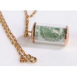 9 carat gold chain link necklace together with a 9 carat gold cased One Pound note rolled up,